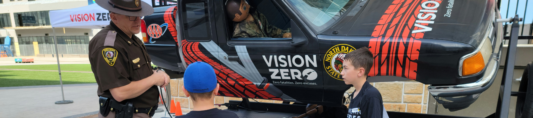 Police officer showing kids the rollover simulator