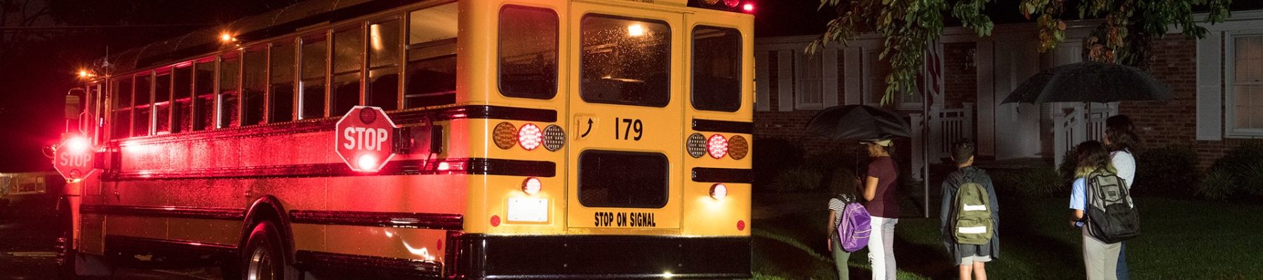 School bus with stop lights waiting for students to board the bus